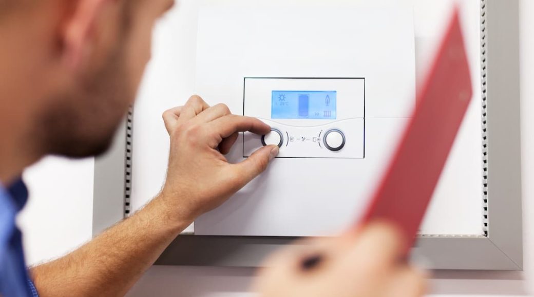 A heating expert running a test on a boiler